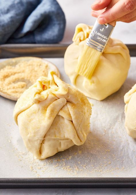 Apple bombs in a baking dish before being baked. Apples In Puff Pastry, Candied Apples Slices, Baked Stuffed Apples, Puff Pastry Apple, Baked Apple Recipes, Apple Puff Pastry, Baked Pears, Apple Recipe, A Spicy Perspective