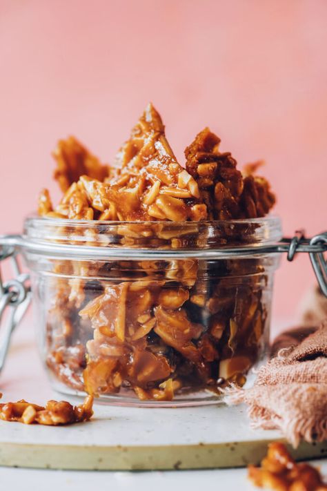 The idea for this brittle came to me one night when I was about to drift off to sleep (as many ideas do). I dreamt of a brittled almond cookie with serious crunch, so we started there. But after a few failed attempts we stopped trying to separate them into clumps and just made almond brittle on a baking sheet, and it was the best, happiest semi-accidental decision ever!  What’s it like? This is like grown-up peanut brittle but with wholesome almonds, natural sweeteners, and no butter in sig Almond Brittle, Almond Cookie, Brittle Recipes, Minimalist Baker, Vegan Ideas, Peanut Brittle, Almond Cookies, Natural Sweeteners, Cream Recipes