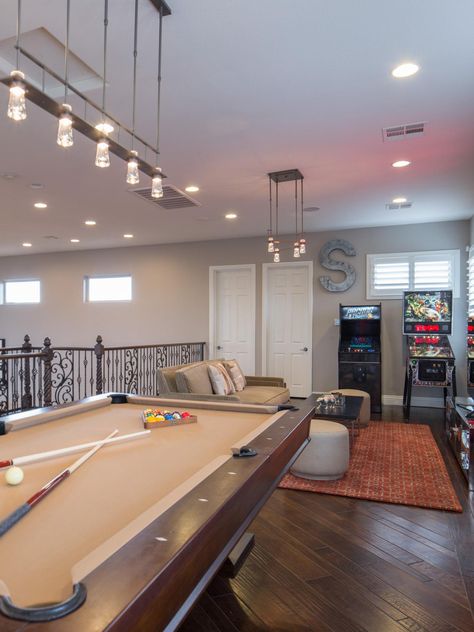 Drew and Jonathan Scott's chic loft game room features a pool table and arcade machine. Sleek, stylish lighting adds personality to the space. Upstairs Loft Ideas, Loft Ideas Upstairs, Loft Game Room, Loft Decorating Ideas Upstairs, Game Room With Pool Table, Game Loft, Game Room Ideas, Small Game Rooms, Pool Table Room