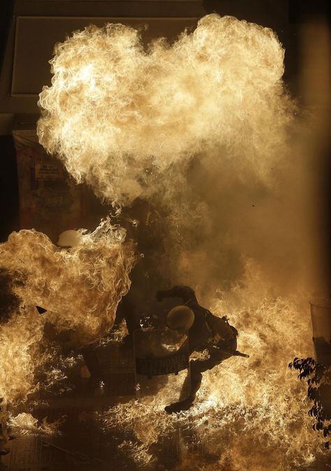 A riot police officer is engulfed by petrol bomb flames thrown by protesters in front of the parliament during clashes in Athens, Wednesday Nov. 7, 2012. Greece’s fragile coalition government faces its toughest test so far when lawmakers vote later Wednesday on new painful austerity measures demanded to keep the country afloat, on the second day of a nationwide general strike. (AP Photo) #fire #world #news General Strike, Riot Police, Star Photography, Military Personnel, Photography Blog, Police Officer, Blog Photography, The Photo, Photo Editor