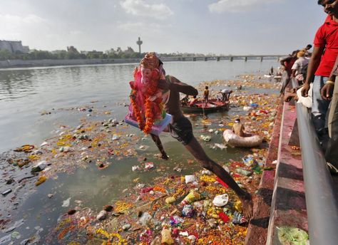 A devotee carrying an idol of the Hindu god Ganesh, the deity of prosperity, jumps into the Sabarmati river to immerse the idol, in Ahmedabad, India, September 27, 2015. Photo by Amit Dave/Reuters. #ganesh #chaturthi #visarjan Ganesh Visarjan, God Ganesh, Ganesh Utsav, The Idol, Male Enhancement, Ganesh Chaturthi, Hindu God, Ahmedabad, Health Wellness