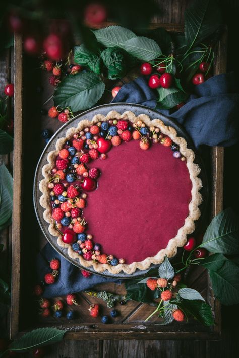 This delicious berry curd tart has a layer of mixed berry jam on the bottom, topped with a creamy & silky smooth berry curd, all on top of an almond crust. Berry Curd, Raspberry Patch, Curd Tart, Mixed Berry Jam, Rustic Food Photography, Almond Crust, Berry Dessert Recipes, Moody Food Photography, Berry Tart