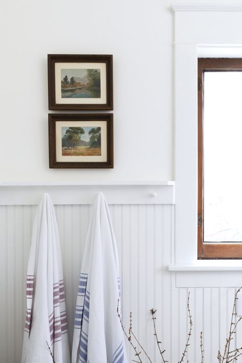 Farmhouse Main Bathroom // Our Quick $1000 Bathroom Remodel is Done! — The Grit and Polish Shaker Pegs Bathroom, Beadboard Bathroom With Shelf, Pegs In Bathroom, White Bead Board Bathroom, Blue Waynes Coating Bathroom, Peg Shelf Bathroom, Towel Pegs Bathroom, Peg Board Bathroom, Vintage Art In Bathroom