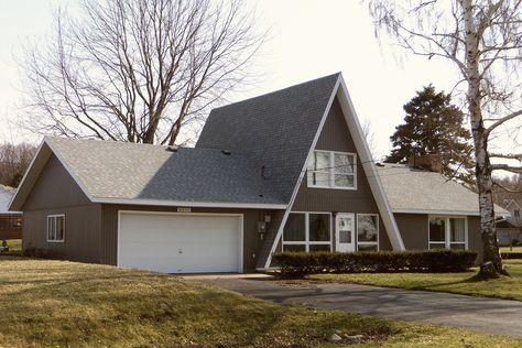 Gray a-frame with garage and addition. Onekama, MI One Level A Frame House, A Frame With Garage Addition, A Frame House Addition Ideas, A Frame House With Garage, A Frame Addition Ideas, A Frame With Garage, Pole Barn Houses, Pole Barn Kits, Pole Barn Plans