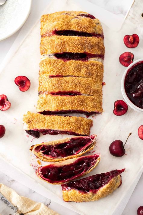 Flaky puff pastry stuffed with a fresh, tart cherries – what could be better than this easy puff pastry cherry strudel for a fruity dessert. A slice of this cherry pastry, still warm from the oven, with a scoop of ice cream is irresistible. Plump juicy cherries, cooked and softened in juice then stuffed into pastry and baked to crispy golden perfection. This easy strudel recipe will become a family favourite. #sugarsaltmagic #strudel #cherries #pastries Cherry Strudel Recipe, Cherry Pastry, Cherry Strudel, Fruity Dessert, Strudel Recipes, Easy Puff, Tart Cherries, Homemade Foods, Cherry Sauce