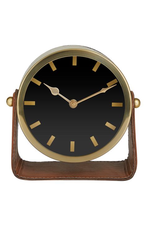 Keep track of time the old fashion way with this stylish clock. A dashing display on any surface to help you manage your time throughout the day. This decorative table clock keeps the time in check while adding spunk to a work desk in a home office. Requires 1 AA battery. Battery not included. This item ships in 1 carton. The clock face is hash marks for numbers. The clock mechanism runs silent. Suitable for indoor use only. Made in India. Modern style. 7.2" x 4.4" x 7.3" Battery Type: AA (not i Modern Mantel, Wooden Laptop Stand, Big Magic, Shelf Clock, Metal Clock, Analog Clock, Mantel Clocks, Leather Stand, Modern Clock