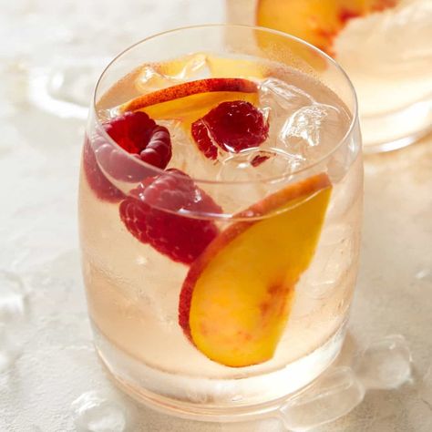 Beat the heat with a glass of this easy Rosé Sangria. Smooth, not too sweet and super refreshing, it's the perfect cocktail for your next backyard BBQ. Easy Batch Cocktails, Rose Sangria Recipes, Peach Rose Sangria, Rum Sangria, Sweet Sangria Recipe, Sweet Sangria, Rosé Sangria, Batch Cocktail Recipe, Rose Sangria