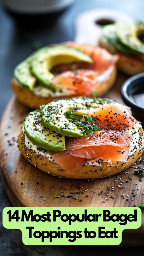 A toasted bagel topped with cream cheese, smoked salmon, avocado slices, and a sprinkle of herbs on a wooden board. Sandwich Bagel Ideas, Bagel Cream Cheese Toppings, Mini Bagels And Cream Cheese, Bagels With Salmon And Cream Cheese, How To Eat Bagels, Dairy Free Bagel Toppings, Salmon Avocado Bagel, Bagels And Cream Cheese Ideas, Popular Breakfast Ideas