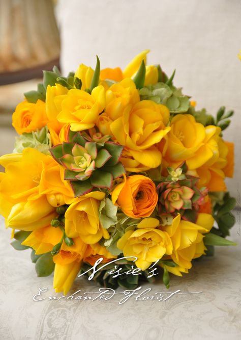 Nisie's Enchanted, With a glowing charm, this bright yellow bouquet screams sunny shine.  It's a mixer of yellow tulips, yellow freesia, yellow ranunculus, with accents light green hydrangea and varying types of succulents, a rejuvenating feel. Succulent Wedding Bouquet, Yellow Freesia, Yellow Rose Bouquet, Yellow Ranunculus, Yellow Weddings, Succulent Bouquet Wedding, Yellow Bouquets, Yellow Wedding Flowers, Types Of Succulents