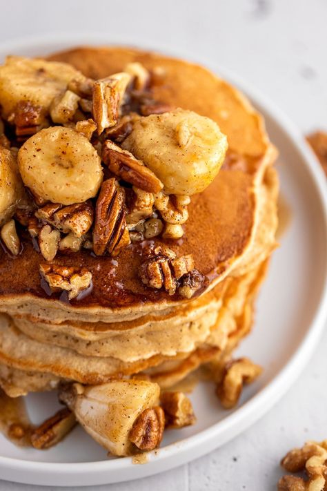 These bananas foster pancakes are the best way to eat pancakes. Ripe bananas are sautéed in a butter, brown sugar, cinnamon and rum extract sauce, with pecans and walnuts mixed in for some crunch. The banana foster sauce is then poured over a stack of fluffy, golden pancakes. Banana Buttermilk Pancakes, Pancakes Oats, Buttermilk Banana Pancakes, Tasty Breakfast Recipes, Bananas Foster Sauce, Banana Foster Pancakes, Buttermilk Pancakes Recipe, Great Breakfast Ideas, Banana Buttermilk