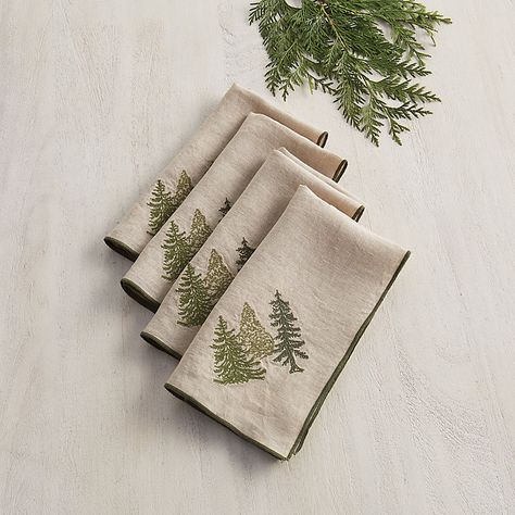 These lovely cloth napkins say holiday with warm, understated style. Designed by our talented resident artist, the charming evergreen tree motif is embroidered in three shades of green on soft flax linen. Each generously sized dinner napkin is trimmed in forest green to complement the subtly festive look. Evergreen Napkin features:  Made of 100% flax linen. Machine embroidered. Machine washable. Imported. Christmas Fairytale, Embroidered Trees, Christmas Linens, Setting Ideas, Embroidery Christmas, Meditation Art, Christmas Napkins, Linen Cloth, Outdoor Cushions And Pillows