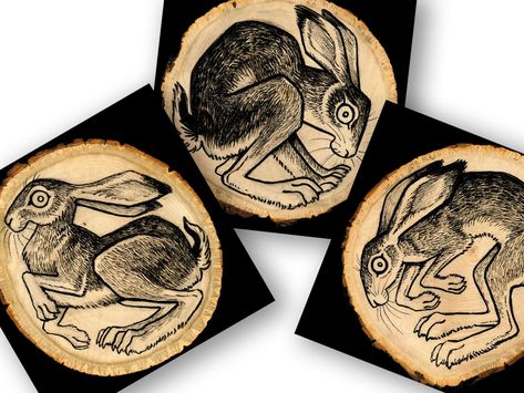 These are high-quality luster paper prints of high-resolution scans of original ink drawings on wood, available in both 5x5 inch (127x127mm) and 11x11 inch (280x280mm) sizes. This is a series of three hares, all in different poses and with different personalities. Choose your favorite or buy all three for a discounted price! PLEASE NOTE: These are square digital prints, not round wooden boards. The black border is part of the artwork. They are printed on a sturdy, high-quality paper and not on w Rabbit Lino Print, Three Hares Tattoo, Drawings On Wood, 3 Hares, Three Hares, Folk Art Prints, Hare Illustration, Wood Printing, Hare Print