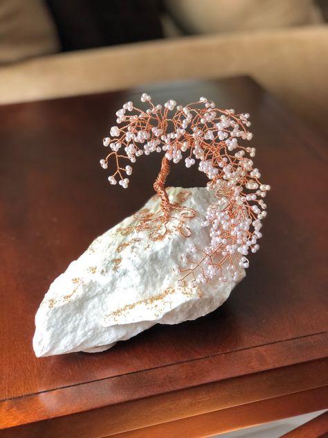 A one of a kind bronze wire bonsai tree sculpture, adorned with white seed beads. Mounted on a landscape large white rock. (Very heavy). Beautiful bronze caviar beads scattered on base. Email for details Radcreativeart@gmail.com Crystal Bonsai Tree, Bonsai Decor, Wire Bonsai Tree, Beaded Trees, Beaded Tree, Beaded Diy, Wire Bonsai, Twisted Tree, Wire Tree Sculpture