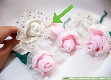 How to Make Flowers Out of Baby Socks: 14 Steps (with Pictures) Baby Socks Flowers, Baby Socks Roses, Sock Bouquet, Diy Baby Socks, Used Socks, Baby Sock Corsage, Baby Corsage, Baby Shower Bouquet, Baby Sock Bouquet