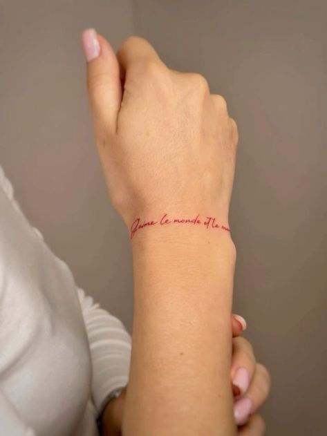 Wrap Around Quote Tattoo, Finger Tattoos Red Ink, Red Tattoo Designs For Women, Red Ink Wrist Tattoo, Con Amor Tattoo, Red Tattoo Hand, Tattoo On Wrist For Women, Womens Wrist Tattoos, Red Wrist Tattoo