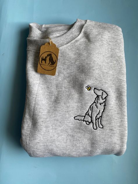 Spring Golden Retriever Outline Sweatshirt - Gifts for goldie owners and lovers. Unisex Embroidered golden retriever  sniffing a bumblebee or butterfly. Unisex breed silhouette line drawing embroidered sweater for dog lovers. The perfect valentines, birthday, Christmas, just because gift for dog lovers and owners! This outline style is perfect for goldie  owners with dogs of any colour or markings! Chose between the lilac butterfly or the bumblebee for extra cuteness! The embroidery is to the left chest. Material: Grey- 80% cotton / 20% polyester Chest To Fit (ins):S- 35-37   M-38-40     L-41-43     XL-44-46  2XL 47-49 Colours: Grey (Black thread) Sky Blue (Black thread) White (Black Thread) Additional info: As these are made to order (to reduce waste) the position of the embroidered desig Embroidery Dog Bandana, Golden Retriever Outline, Golden Retriever Embroidery, Lilac Butterfly, Golden Retriever Shirt, Golden Retriever Gifts, Bday List, Garden Embroidery, Clothes Wishlist