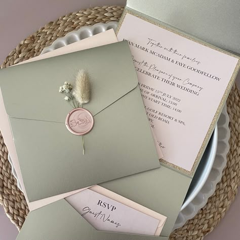 Personalised Wedding invitations with beautiful sage green shimmer pocketfolds, wax seals and dried flowers. The elegant design of the pockets is paired with blush pink shimmer outer envelopes.Format: Pocket FoldShape: SquareColour: sage green shimmer pocket and blush pink shimmer outer envelopeItems included:- Sage Gr Green And Pink Wedding Theme, Sage Green And Pink Wedding, Sage Green And Blush Wedding, Pink And Sage Green Wedding, Sage And Blush Wedding, Pink Green Wedding, Pocket Fold Wedding Invitations, Green Invitations, Pink Wedding Theme