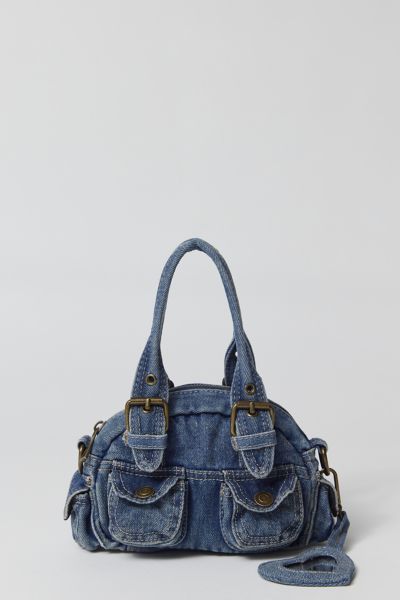 Essential denim bag from BDG with Y2K styling. Mini duffle style with a zippered top and snapped pouch pockets. Trimmed with a hear-shaped mirror charm and finished with a removable crossbody strap. Only at Urban Outfitters. Features. Denim 2000s bag from BDG in a mini silhouette Zipper closure with a removable crossbody strap UO exclusive Content + Care. 100% Cotton Spot clean Imported Y2k Duffle Bag, Urban Outfitters Denim Bag, Aesthetic Purses And Bags, Denim Purses And Bags Old Jeans, Bag Out Of Jeans, Cute Bags And Purses, Cool Purses, 2000s Bags, Jeans Purse