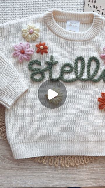 Little Looks by Lilly on Instagram: "Making the winning spring sweater design! What do we think?! I’m loving these colors together; chunky Sage for the name, extra chunky bubble, chunky moon, and chunky pumpkin for flowers! 🌸 you can order this exact design with your Little’s name today during our drop! 0-3m up to 2-4T available for this design #custom #handembroidery #sweater #littlelooksbylilly" Name Sweater, Spring Sweater, Chunky Knits Sweater, Sweater Design, Embroidery Flowers, Chunky Knit, Hand Embroidery, Desi, Must Haves