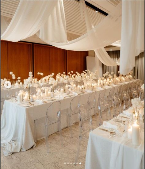 Monochromatic Wedding Reception, Transparent Chairs Wedding, Wedding Venue Drapery Ideas, White Satin Tablecloth Wedding, White Drapery Wedding, White Linens Wedding, Wedding Tablescapes Long, Ivory Table Cloth, Sophisticated Wedding Reception