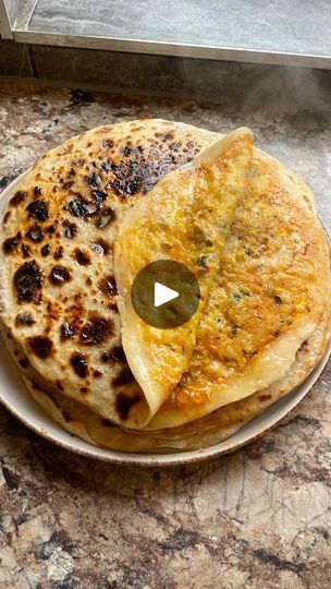 115K views · 9.2K reactions | Here’s my ✨special✨aloo paratha recipe. A classic Punjabi breakfast (or dinner) with a cheesy, spicy twist. You’re going to absolutely love this one guys! Try it this weekend. Recipe below 👇🏾 

8 parathas:

500g flour
4 tablespoons yoghurt
1/4-1/2 cup boiling water 
1/2 salt
1 tsp sugar 
4 medium potatoes
1 small onion
2 tsp garam masala
1.5 tsp chilli powder
1/2 tsp black better
1/8 tsp turmeric
Salt to taste
Corriander 
Mature cheddar
Chilli oil

#alooparathas #alooparatharecipe #alookiparathas #paratharecipe | Zaynah | Desified Recipes & Travel Aloo Paratha Recipe Punjabi, Punjabi Breakfast, Chai Party, Yummy Asian Food, Weekend Recipe, Aloo Paratha, Paratha Recipe, Chilli Oil, Paratha Recipes