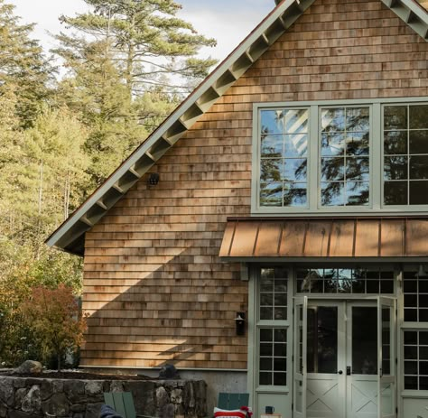 The barn-like, timber-framed structure is both rec room and guesthouse, with a kitchenette and an upstairs bedroom.