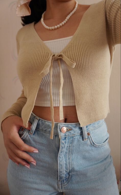 I love this outfit. It shows a preppy minimalist look for young girls that are trying to find for cute outfits. #beige #beigeaesthetic #pearls #outfits #clothes #cardigan Small Cardigan Outfit Aesthetic, Tiny Cardigan Outfit, Beige Cropped Cardigan Outfit, Little Cardigan Outfit, Light Cardigan Outfit, Cropped Cardigan Outfit Aesthetic, Khaki Cardigan Outfit, Tight Cardigan Outfit, Small Cardigan Outfit