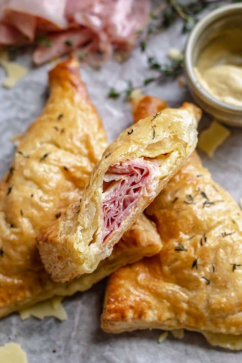 These quick ham and cheese turnovers are made with puff pastry and taste like an elevated version of a hot ham and cheese sandwich! Filled with ham, sharp aged cheddar, and dijon mustard, these savory turnovers are perfect for a snack, appetizer, or meal. Puff Pastry Ham And Cheese, Puff Pastry Turnovers, Ham And Cheese Puff Pastry, Pastry Turnovers, Cheese Turnovers, Homemade Pot Pie, Puff Pastry Pockets, Rough Puff Pastry, Pastry Appetizer