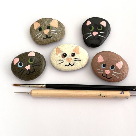 Add some feline charm to your home with these adorable kitty pebbles!   Perfect for cat lovers, these hand-painted pebbles are part of my Cool for Cats Collection.   Get your paws on this set of 5 now in my online shop!     To purchase some of my painted rocks, you can use my shop's website link: creationsjdb.com/shop-hand-crafted-art-stones/  #catlovers #coolcats #handpaintedpebbles Rock Painting Cats Easy, Simple Stone Painting, Cat Stone Painting, Cats Painted On Rocks, Painted Rock Cat, Stone Painting Animals, Painted Rocks Cats, Cat Rock Painting Ideas, Simple Painted Rocks