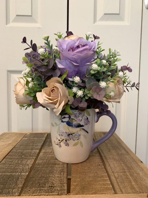 This ceramic bird mug is so pretty (and the flowers are too!). The best part about this arrangement is that you can remove the flowers, wash the mug, and then enjoy a hot beverage! Simply put the flowers in a new container such as a basket or vase! A wonderful gift idea. Coffee Mug Flower Arrangement, Bird Mug, Flowers Lavender, Floral Arranging, Artificial Floral Arrangements, Anniversary Flowers, Silk Floral Arrangements, Lavender Roses, Ceramic Birds