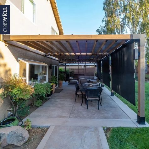 16 Modern Pergola Ideas To Spruce Up Your Yard – Forbes Home Attached Pergola Ideas, Modern Pergola Ideas, Modern Pergola Designs, Black Pergola, Attached Pergola, Wooden Lounge Chair, Back Of House, Modern Pergola, Metal Pergola