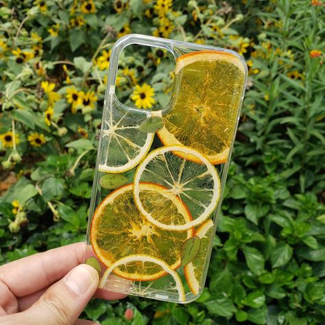 100% Real Dried Pressed flowers case for your phone. It can decorate and protect your phone well. Ingenious and exquisite design adds color and charm to your phone! This handmade phone case is made by using real dried lemons and oranges, high quality crystal clear case and high quality resin. Its bottom is hard and its four sides are soft, which can protect your phone well to avoid scratching it. It is durable and easy to be installed, and has easy access to phone port and button. More designs: Pressed Flowers Case, Lemon Phone Case, Resin Phone Case, Phone Things, Dried Pressed Flowers, Handmade Phone Case, Orange Slice, Dried And Pressed Flowers, Floral Phone Case