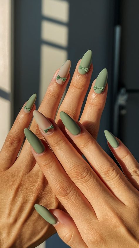 Achieve a chic and sophisticated look with elegantly designed matte sage green nails, adorned with charming bow accents. Perfect for adding a touch of refined glamour and subtle sophistication to any outfit. Elevate your style with this stylish and graceful manicure! 🌟💚 : #MatteSageNails #ChicNails #BowAccents #ElegantManicure #SophisticatedNails #StylishNails #RefinedLook #NailArt #NailDesigns #FashionNails #PolishedNails #NailInspo #GracefulNails #ModernManicure #NailTrends #FeminineNai Sage Green Nails Medium Length, Matte Sage Green Nails, Sage Green Almond Nails, Sage Green Nail Designs, Sage Green Nail Ideas, Sage Nails, Matte Almond Nails, Martini Nails, Matte Green Nails