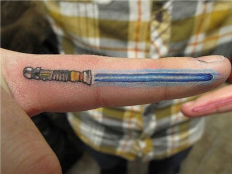 Glow in the Dark Light-saber Tattoo Lightsaber Tattoo, Simple Finger Tattoo, Middle Finger Tattoos, Star Wars Lightsaber, Uv Tattoo, Finger Tattoo Designs, Finger Tattoo, Star Wars Tattoo, Dark Tattoo