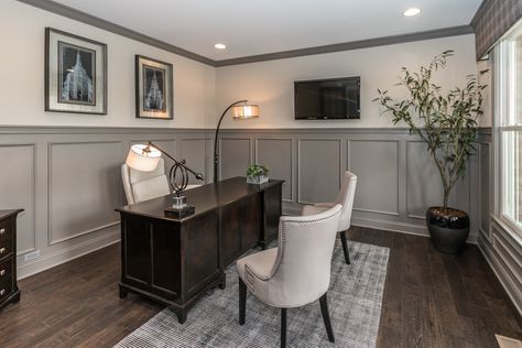 Gray wainscoting in this home office makes your space feel dignified and professional. Seen in the Wheatland at Thorpe Creek located in Fishers, Indiana. | Fischer Homes Home Office Trim Work, Gray Wainscoting Dining Room, Home Office Wainscoting, Office Wainscoting Ideas, Wainscoting Office, Gray Wainscoting, Modern Wainscoting Ideas, Fischer Homes, Fishers Indiana