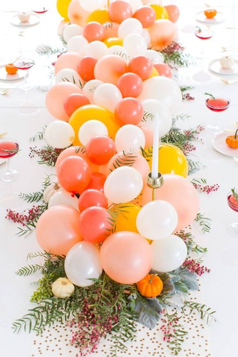 15 ways to decorate a table with balloons How To Decorate An Easel With Balloons, Balloons Tied To Chairs, Rainbow Balloon Centerpiece, How To Put Balloons Inside Balloons, Decorating With Balloons, Diagonal Balloons On Hoop, Balloons With Confetti Inside, Balloon Centerpiece, Rainbow Balloons