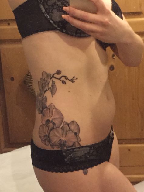 Orchid hip and side tattoo Orchid Hip Tattoo, Year Tattoo, Orchid Tattoo, Ribcage Tattoo, Dragon Year, Stomach Tattoos, Red Tattoos, Side Tattoos, Rib Tattoo