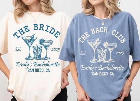 The Bach Club Shirt, Custom Location Bachelorette Shirt, Personalized Bride Shirt, Future Bride Shirt for Bridal Party, Bridesmaid Shirt, 1456 -If you would like any other color of t-shirt, sweatshirt, hoodie, etc., please let me know by sending a message. I will provide it for you. ----------- How to Order Your Custom Design T-shirt ---------- * Choose your t-shirt color * Choose your size * PLEASE make sure all your order's steps Comfort Colors introduces the "Comfort Colors 1717" garment-dyed t-shirt; a fully customizable tee made 100% with ring-spun cotton. The soft-washed, garment-dyed fabric brings extra coziness to your wardrobe while the relaxed fit makes it an excellent daily choice. The double-needle stitching throughout the tee makes it highly durable while the lack of side-seam Bridesmaid Shirt, Bachelorette Shirt, Bride Shirt, Bridesmaid Shirts, Personalized Bride, Bride Shirts, Bachelorette Shirts, Future Bride, Club Shirts