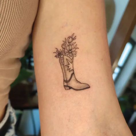 Small Dotwork Blooming Flower Cowboy Boot Tattoo Idea & Design on Woman Bicep Blooming Flower Cowboy Boot Tattoo Done At Cowboy Boot With Flowers Tattoo, Cowboy Boot Tattoo, Mud Boots, Small Flower Tattoos, Cowboy Boots Women, Fine Line Tattoos, Blue Bonnets, Rose Tattoos, Line Tattoos