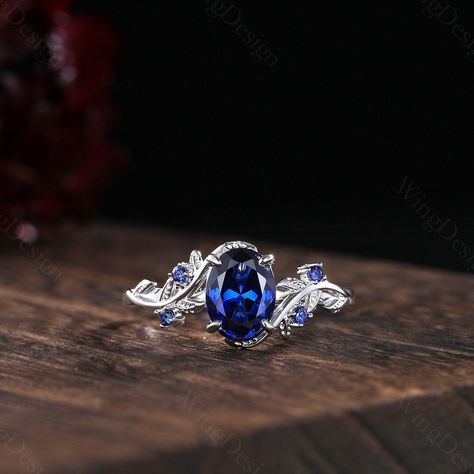 Oval cut blue sapphire engagement ring women silver gold ring unique art deco leaf ring nature branch ring September birthstone promise gift -----Ring Information----- Metal Type: 925 sterling silver, 10K/14K/18K Solid Gold, Platinum Center stone: Lab blue sapphire Stone size: 6x8mm oval shaped Side stone: Blue sapphire (contact me if you need other stones) ✦ Please feel free to contact me if you have any questions or you are interested in custom order. ✦Our Service: Custom Order All Sizes Engra Luxury Heirloom Sapphire Promise Ring, Engagement Rings Silver Sapphire, Wedding Rings With Sapphires, Silver Sapphire Engagement Ring, Sapphire Engagement Ring Silver, Blue Stone Engagement Ring, Engagement Ring Blue Stone, Silver Sapphire Ring, Blue Sapphire Wedding Ring