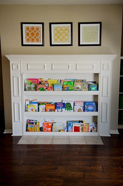 Pretty Toy Room - but completely inspired bookshelf inserted into fireplace. Make use of that space while it isn't being used as a fireplace. Playroom Fireplace Mantle, Fireplace Into Bookshelf, Convert Fireplace To Bookshelf, Converted Fireplace, Playroom With Fireplace, Nursery Fireplace, Playroom Fireplace, Fireplace Covers, Kids Rooms Shared