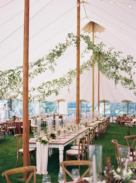 sailcloth tent wedding with farmhouse tables and suspended greenery Greenery In Wedding Tent, Garden Tent Wedding Reception, Tent Wedding Greenery, Sailcloth Tent Wedding Lighting, Greenery Tent Entrance, Tent Wedding Fall, Sailcloth Wedding Tent, Sail Tent Wedding Reception, Sailcloth Tent Wedding Decor