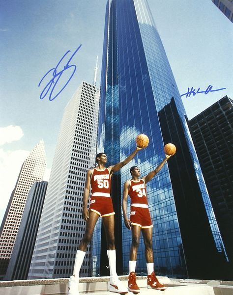 Photo measures 16" x 20" in size and is hand-signed in blue felt tip pen by both Hakeem Olajuwon and Ralph Sampson. Hakeem Olajuwon and Ralph Sampson combined to form a duo dubbed the "Twin Towers". The two led the Rockets to the 1986 NBA Finals.   The autographs include an official Steiner hologram and matching COA for authenticity purposes.   Authentication: Steiner COA Michael Jordan Unc, Heart Of A Champion, Jordan Unc, James Russell, Rockets Basketball, Houston Skyline, Ralph Sampson, Hakeem Olajuwon, Abdul Jabbar