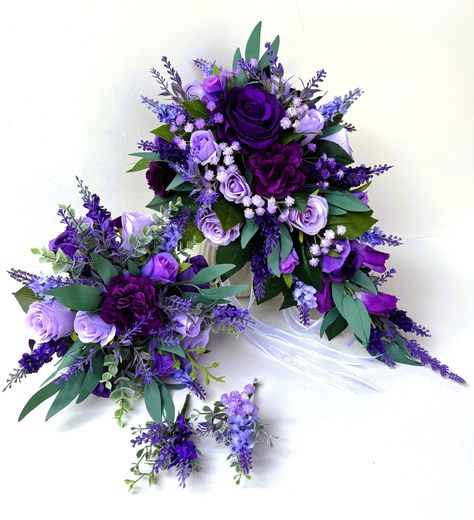 Bridal teardrop bouquet 45 cm long and 27 cm across . Finish with white ribbons  Bridesmaids bouquet 23 cm across , finish with purple ribbon We have two styles of buttonhole available . Blue Purple Bouquet Wedding, Purple Woodsy Wedding, Dark Purple Wedding Bouquets, Purple And Navy Blue Wedding, Purple And White Bouquet, Purple Bride Bouquet, Wedding Bouquet Purple, Bridal Bouquet Purple, Royal Purple Wedding