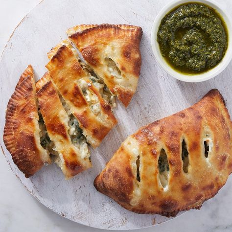 Recipe: Spinach & Artichoke Calzones with Basil Pesto - Blue Apron Spinach Basil Pesto, Recipe Spinach, Crispy Pizza, Bechamel Sauce, Blue Apron, 2000 Calories, Artisan Cheese, Spinach Artichoke, Creamy Cheese