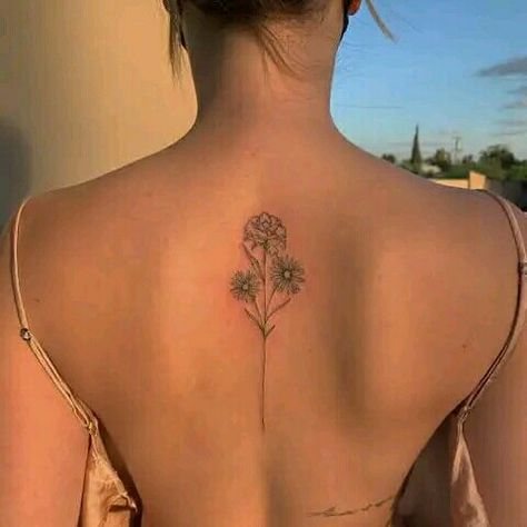 Back tattoo ideas for women Flower Bouquet Tattoo On Spine, Flower Spine Tattoos Simple, Fine Like Spine Tattoo, Carnation Tattoo Spine, Upper Back Flower Tattoo Women, Simple Line Spine Tattoo, Minimalist Back Tattoo Women Spine, Dainty Flower Back Tattoo, Medium Size Back Tattoos