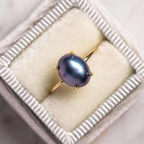 This stunning ring looks like it could be a vintage heirloom. Crafted in 14k solid yellow gold so that it will last forever, its natural black pearl center glows with iridescent colors. Bluish black Mabe pearl 10.5 x 8.5 mm 14k solid yellow gold Band width 1.1 mm Black Pearl Engagement Ring, Cuz Cuz, Pearl Promise Rings, Jewelry Redesign, Pearl Ring Vintage, Pearl Gold Ring, Black Pearl Jewelry, Black Pearl Ring, Rings Pearl