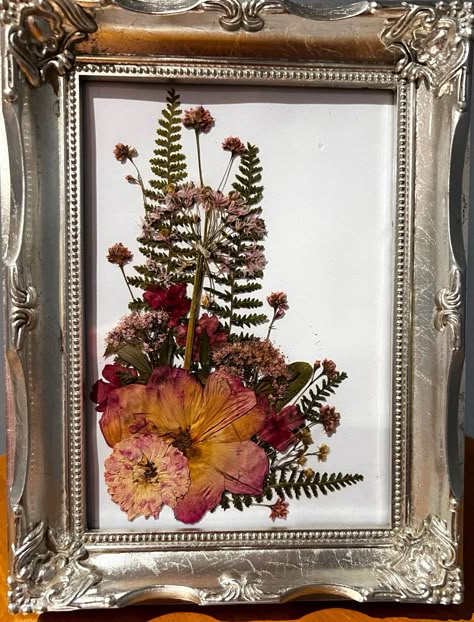 "Pressed Flower Art: Pressed roses, ferns and delicate pink wild flowers displayed in an artistic spray on a white background.  Silver painted, 7\"x9\" frame is free-standing or ready to hang on a wall" Pressed Fern Art, Press Flower Art, Pressed Leaf Art, Pressed Flower Art Picture Frames, Diy Pressed Flower Art, Framed Dried Flowers, Pink Wild Flowers, Framed Pressed Flowers, Pressed Roses