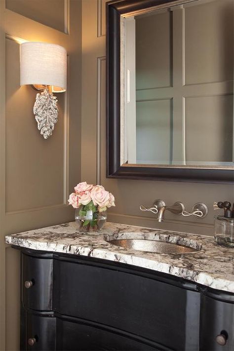 Taupe and black powder room features taupe walls accented with taupe trim moldings lined with a black dresser turned washstand topped with black and white granite fitted with a hammered metal sink and a wall mount faucet under a black beveled mirror. Black And White Powder Room, Black Powder Room, Taupe Bathroom, Traditional Powder Room, Taupe Walls, Best White Paint, Powder Room Design, Bathroom Paint Colors, Brown Bathroom