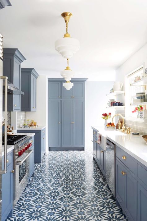 Moroccan interior design has its roots in the East, emphasizing fluid lines, contrasting vibrant hues, luxe fabric and, possibly the most defining characteristic of all, tile featuring geometric patterns which grace doorways, furniture, and floors. #hunkerhome #moroccan #kitchen #kitchenfloor #flooring #moroccantile Long Narrow Kitchen, Blue Kitchen Walls, Blue Kitchen Designs, Moroccan Kitchen, Narrow Kitchen, Blue Kitchen Cabinets, Floor Tile Design, Kitchen Paint Colors, Blue Cabinets